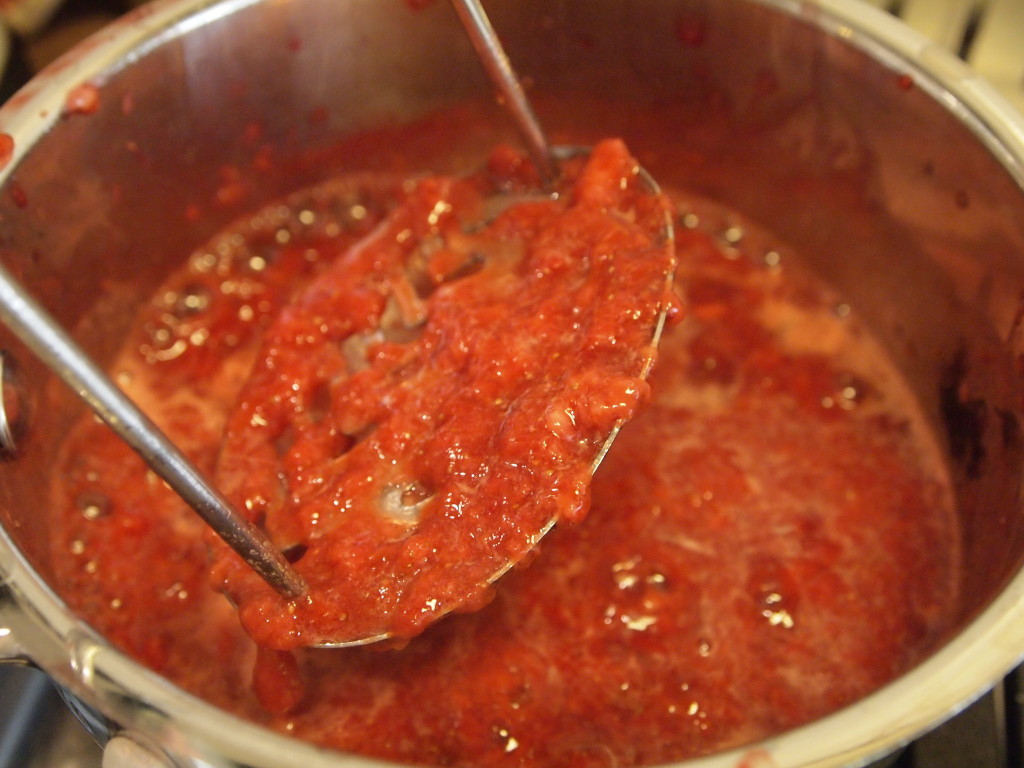 Mashed strawberries in a saucepan